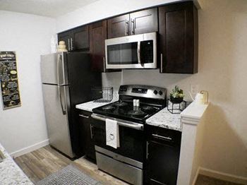 Fully equipped kitchen includes frost-free refrigerator, electric range, & dishwasher